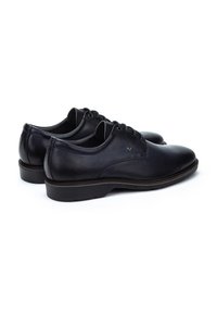 Chaussures noires en cuir avec une texture lisse, bouts ronds, design à lacets et une semelle en caoutchouc basse. Présentent un logo subtil sur le côté.