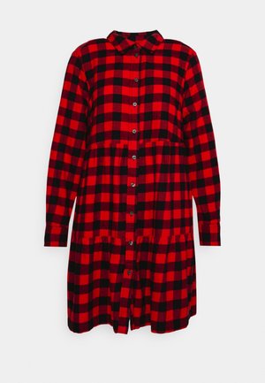 Red and black checkered shirt dress with a collar, button front, long sleeves, and tiered skirt design. Soft fabric texture.