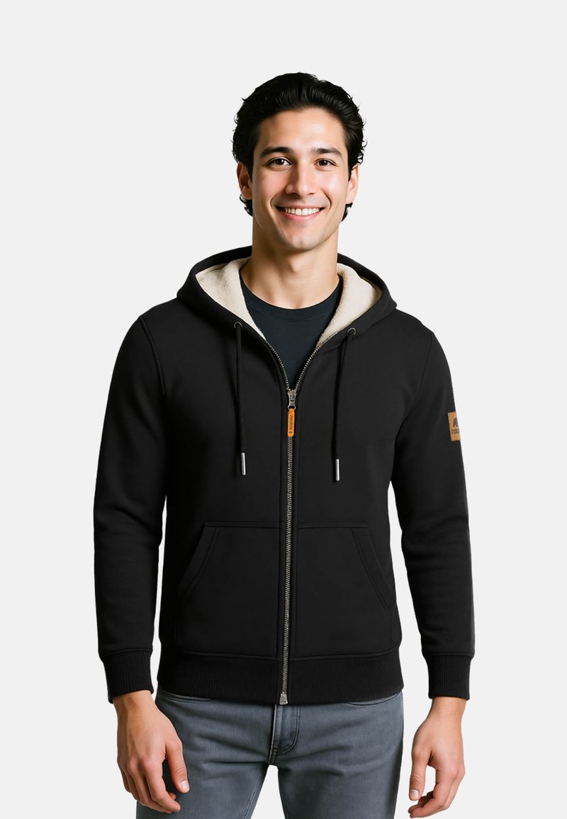 Felpa nera con zip, cappuccio foderato in pile crema, tasche a marsupio, polsini a coste e un dettaglio arancione sulla cerniera.