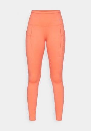 Høyt liv, tettsittende tights i lys korall, med sidelommer og kontraststing for ekstra detaljer. Laget av stretchy stoff.