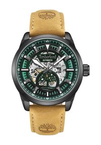 Montre automatique Timberland avec un boîtier noir, un cadran vert et un fond transparent. Elle est dotée d'un bracelet en cuir tan avec un logo embossé.