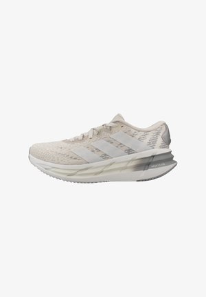 Light beige Adidas running shoe with textured upper, three stripes on side, cushioned sole, and "Repetition" text on heel.