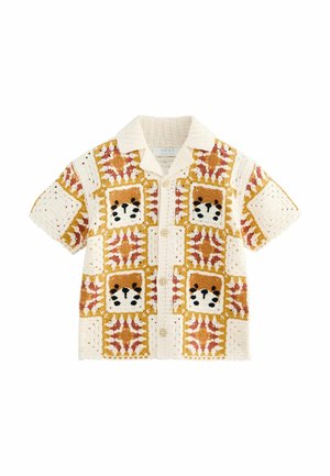Kortærmet skjorte med et patchwork-design med dyremotiver. Farverne inkluderer creme, brun, orange og rød. Tekstilt stof med knapper.