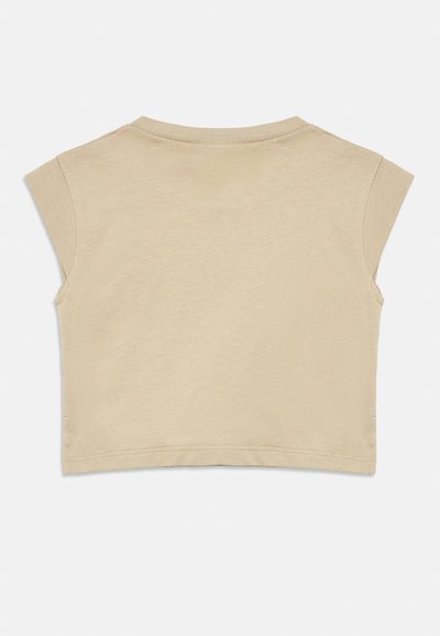 Rövid ujjú, rövidített felső világos bézs színben, puha pamutból készült. Kerek nyakkivágással és sima, minimális varrásokkal rendelkezik.