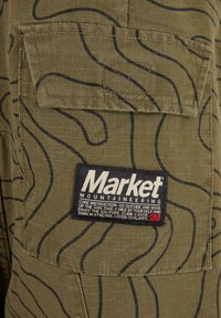 Market MORAINE - Reisitaskuhousut - kelp