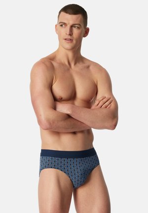 Herenboxershort met een donkerblauwe tailleband en een geometrisch patroon in lichte en donkere blauwtinten, gemaakt van een glad, rekbaar materiaal.