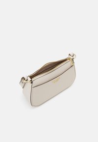 Beige leather crossbody bag with a curved shape, gold hardware, and a zip closure. The interior features a brown lining.