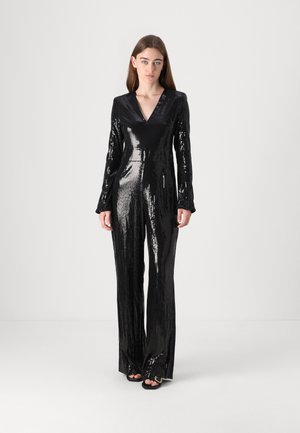 Black sequined jumpsuit with a V-neck, long sleeves, tailored fit, and straight legs, reflecting light with a glossy texture.