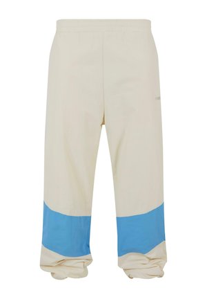 Beige bukser med en bred blå stribe nær kanten. Lavet af blødt stof, med elastisk talje og en afslappet pasform.