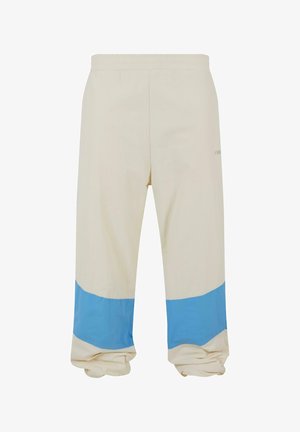 Beige bukser med en bred blå stribe nær sømmen. Lavet af blødt stof, med elastisk talje og afslappet pasform.