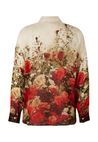 Blumiges Hemd mit cremefarbenem Grund und großen roten und weißen Rosen. Weicher Stoff, lange Ärmel und ein Kragen-Detail. Auffälliges Blumenmuster.