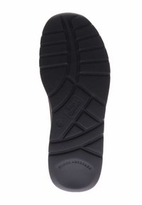 Zwarte rubberen schoenzool met diepe groeven voor grip, met het reliëf "Shock Absorber"-logo en de merkmarkering "Elan Comfort" zichtbaar.