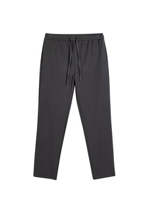 Grå joggebukser lavet af blødt stof med elastisk talje og snøre, elastiske manchetter og sidelommer, der har en glat overflade og en tætsiddende design.