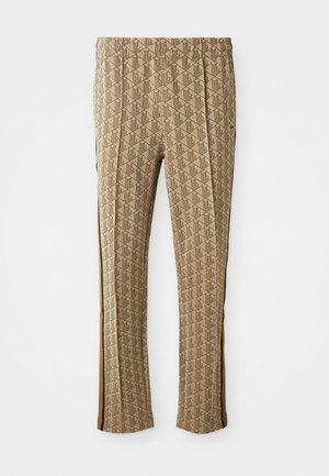 Brown patterned pants with an elastic waistband and side stripes. The design features a geometric motif in varying shades of brown and cream.