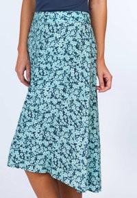 Floral skirt featuring a navy background with light aqua flowers, A-line design, and textured fabric. Hemline is slightly asymmetrical.