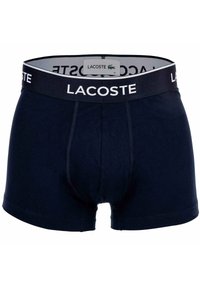 Boxer da uomo Lacoste in blu navy con elastico nero, caratterizzato da logo Lacoste bianco e un'etichetta interna con il logo del marchio.