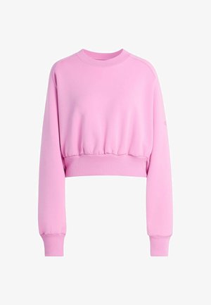 Rosa kort sweatshirt med långa ärmar, ribbade cuffs och en samlad nederkant. Mjukt tyg med en slät textur. Inga synliga mönster.