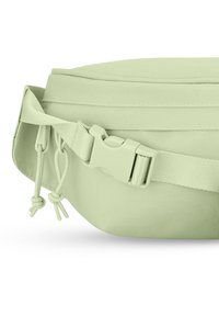 Light green fanny pack made of textured fabric, featuring a curved shape, adjustable strap, and a plastic buckle for secure fastening.