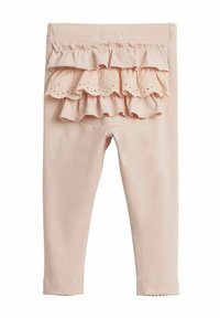 Des leggings roses présentent une couche volante avec un bord festonné et des détails en œillet à l'arrière. Le matériau est doux avec un design ajusté.