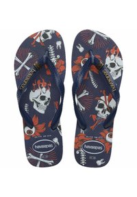Infradito blu con motivo di teschi e fiori con dettagli rossi, cinturini in gomma, soletta con texture e logo Havaianas sulla suola.
