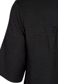 Black short-sleeve top with a textured finish, featuring a smooth neckline and slightly gathered back detail.