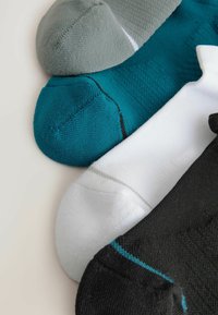 Tri páry ponožiek v sivej, tealovej, bielej a čiernej farbe. Každá ponožka má textúrovanú látku s kontrastnými farebnými akcentmi pri manžetách.