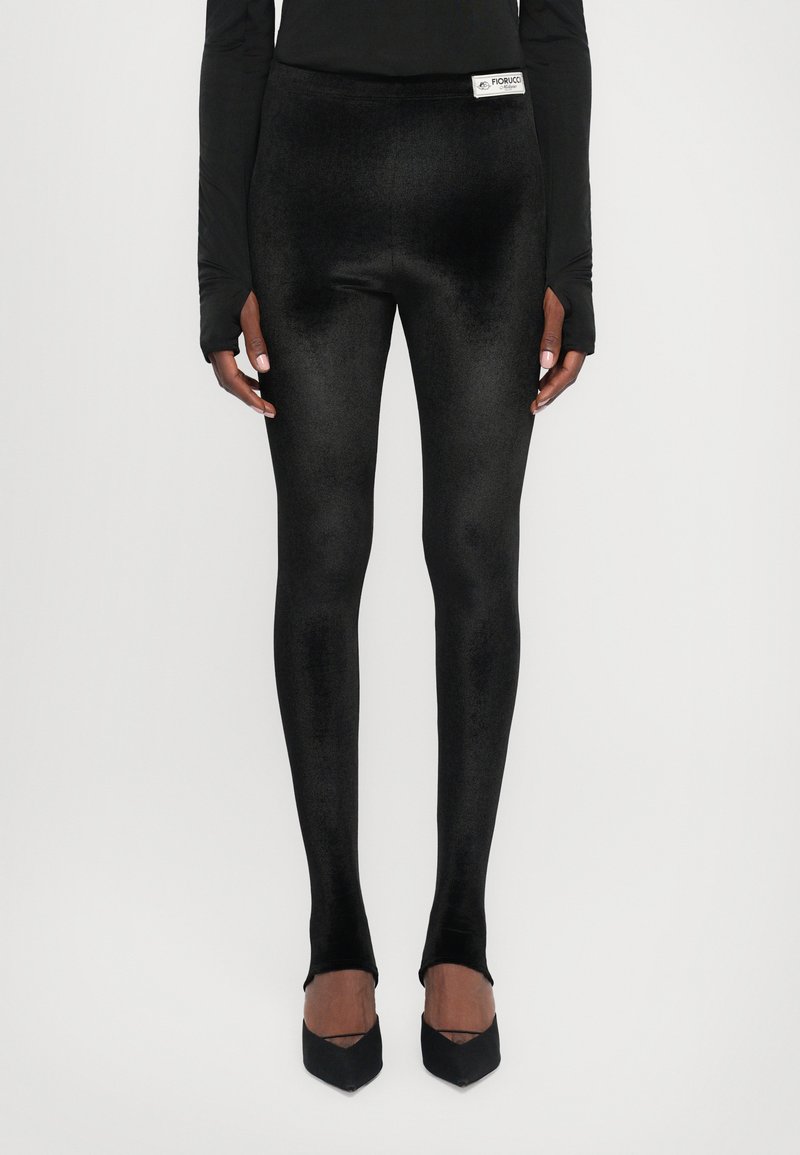 Black leggings made from a smooth, stretchy material, with a high waistband and a logo tag on the front. Subtle sheen texture.