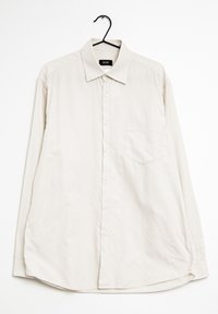 Ljust beige långärmad skjorta med rutigt mönster, knappstängning, krage och en enda bröstficka. Hänger på en svart krok.