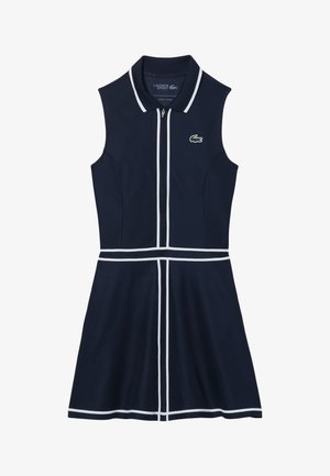 Abito senza maniche color blu navy con cerniera frontale, dettagli bianchi sul colletto e in vita, e un piccolo logo verde sul petto a sinistra in alto.