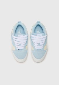Blue and cream sneakers with a suede and fabric upper, white laces, and a white rubber sole. Logo on the tongue, low-top design.