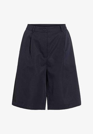 Short large bleu marine longueur genou avec bouton et fermeture éclair, plis latéraux et passants de ceinture.
