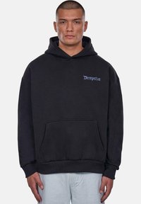 Black hoodie made of cotton, featuring a front pocket, ribbed cuffs, and a stitched logo in blue on the left chest area.