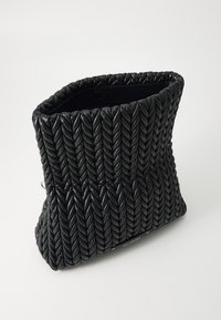 Black braided leather bag with a textured, woven design. Features a soft, rounded shape and an open top, suitable for various accessories.
