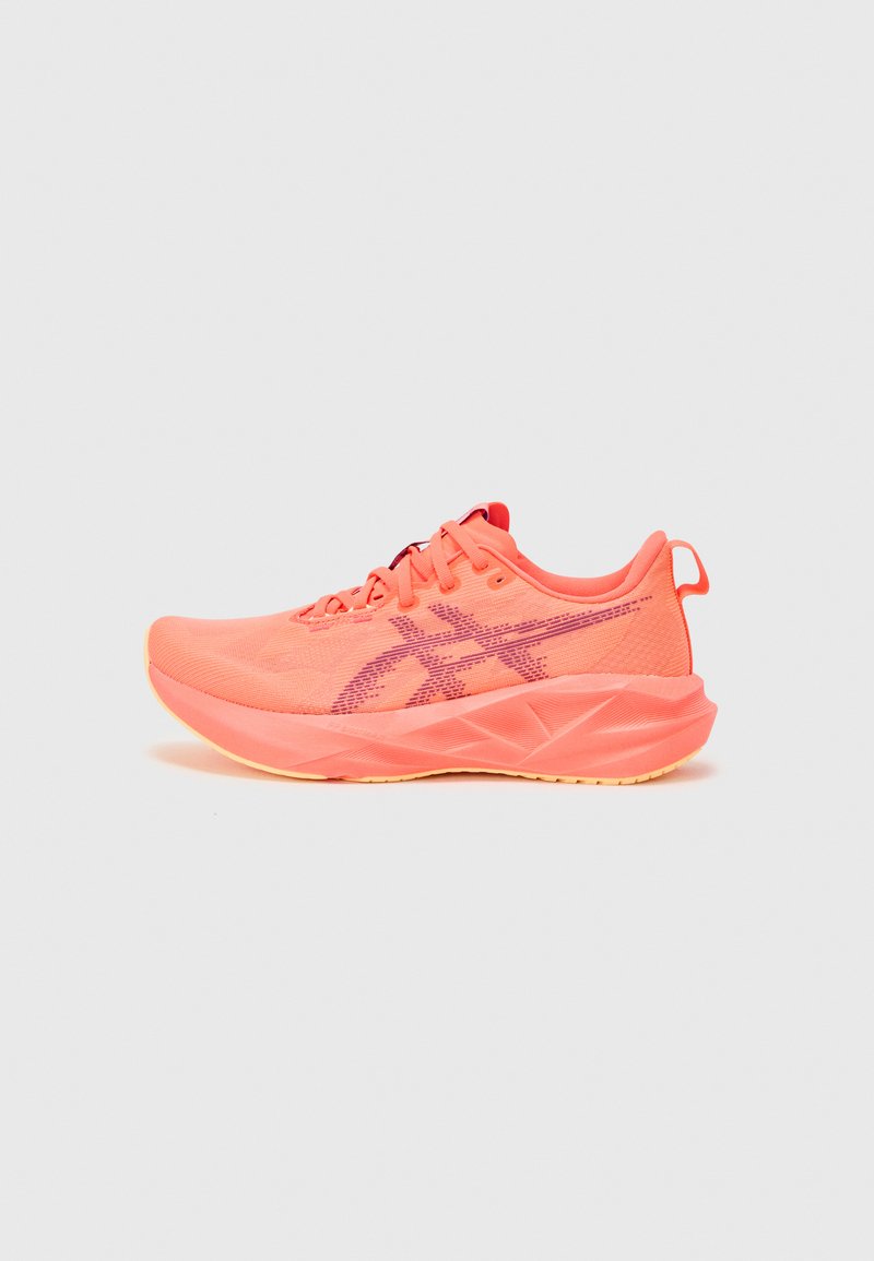 Lightweight running shoes in bright coral with mesh upper, patterned detailing, contrasting purple logo, and textured rubber sole.