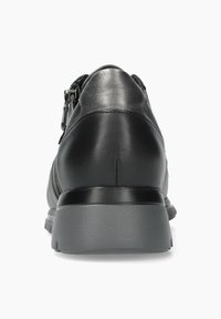 Chaussure en cuir noir à la finition lisse, de forme arrondie, avec une semelle en caoutchouc grise. Équipée d'une fermeture à glissière et de détails minimalistes au niveau du talon.