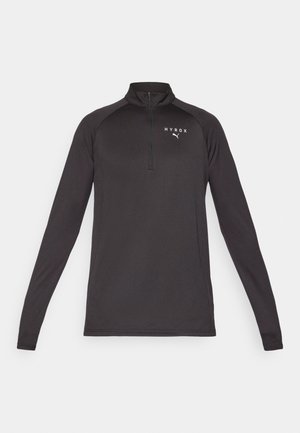 Black long-sleeve pullover with a quarter zip, made from a smooth fabric. Features a white logo on the left chest area.