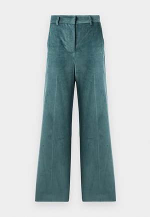 Pantalons en velours côtelé de couleur sarcelle, présentant des jambes larges et une texture rayée verticale. La taille est plate avec des passants de ceinture.