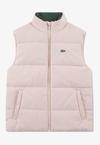 Roza puhasta brezrokavca z visokim ovratnikom, z zadrgo in dvema stranskima žepoma. Ima zeleno notranjo podlogo in majhen zelen logotip.