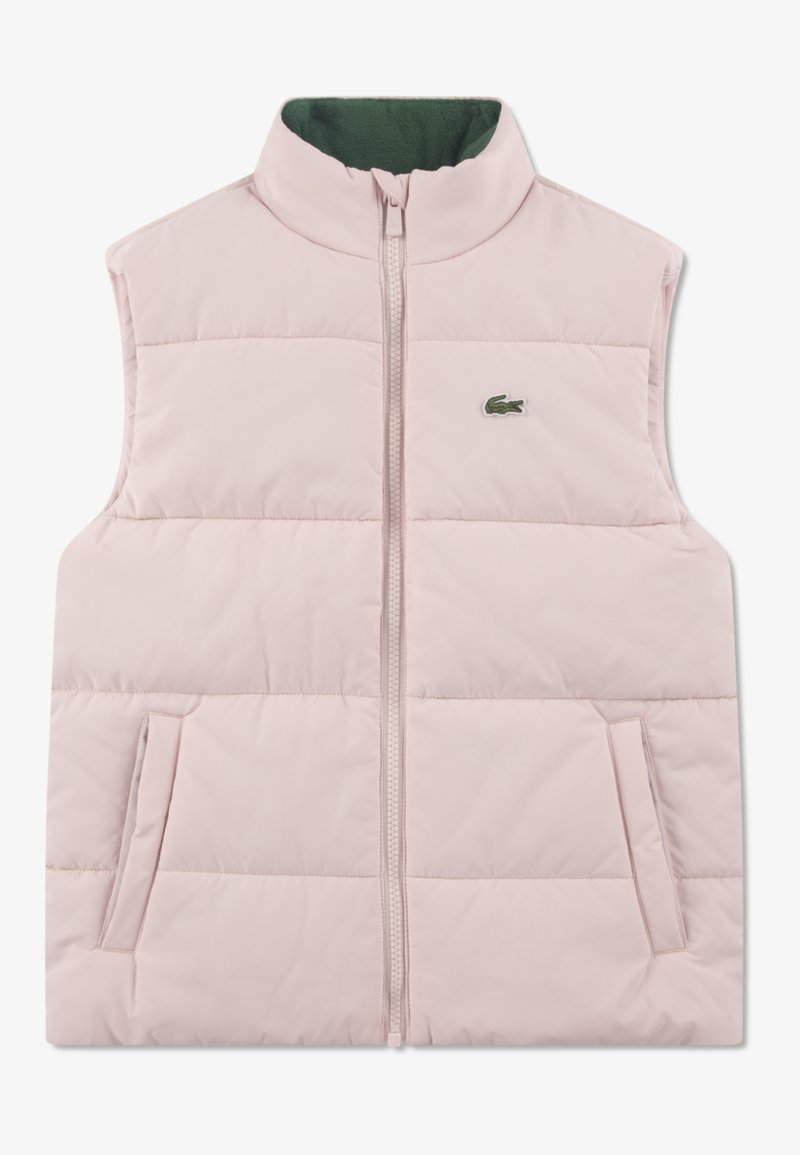 Roza puhasta brezrokavca z visokim ovratnikom, z zadrgo in dvema stranskima žepoma. Ima zeleno notranjo podlogo in majhen zelen logotip.