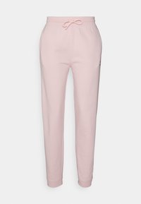 Jasnoróżowe dresy wykonane z miękkiej bawełny, z elastycznym pasem ze sznurkiem oraz ściągaczami na kostkach.