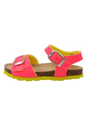 Sandales néon roses avec des brides plus larges, des boucles en argent, une semelle en liège et une semelle en caoutchouc jaune. Présente une surface texturée et un design ouvert.