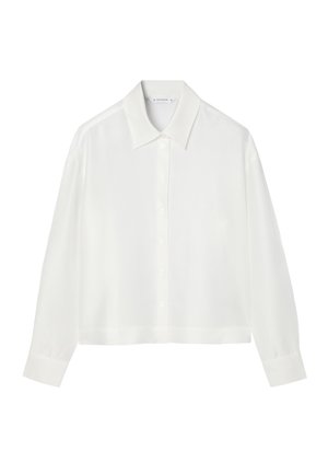 Valge pika varrukaga pluus laia krae, nööbitava esiosa ja pehme, siledast kangast. Omaduseks lühem lõige ja tavalised mansetid.