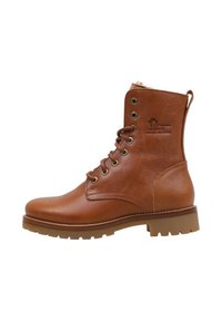 Bota de tobillo de cuero marrón con puntera redonda, suela resistente y cordones de seis ojales. Presenta un logo en el lateral y un forro suave en el cuello.