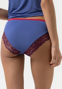 Blue cotton underwear with burgundy lace trim along the edges, featuring a low-rise design and a contrasting red waistband.