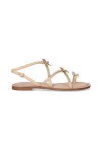 Sandalias planas beige con tres adornos decorativos de mariposa, correas de cuero suaves y un diseño sencillo, que cuentan con una suela plana de goma.