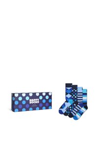 Coffret-cadeau coloré de chaussettes avec des pois bleus, blancs et navy, comprenant quatre paires de chaussettes à motifs et rayées dans différentes nuances de bleu.