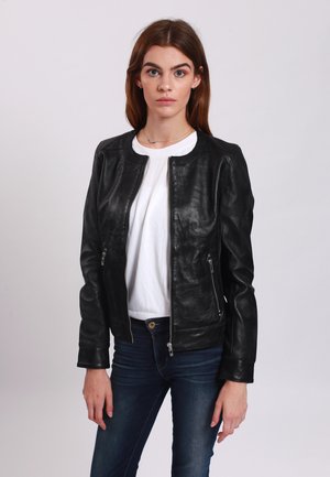 Black leather bomber jacket with a round neckline, front zippers, and side pockets, paired with a white shirt and blue jeans.