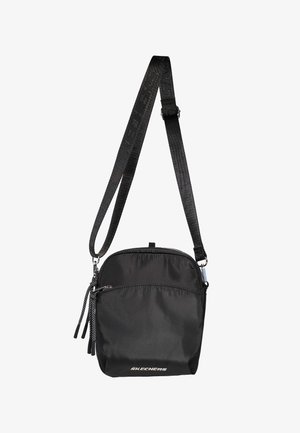 Sac bandoulière compact noir avec sangle texturée réglable, poche zippée à l'avant et logo "Skechers" en bas au centre devant.