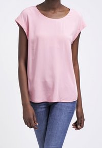 Blusa rosa chiaro a maniche corte con scollatura tonda, realizzata in tessuto morbido, con una vestibilità ampia e orli arrotolati.