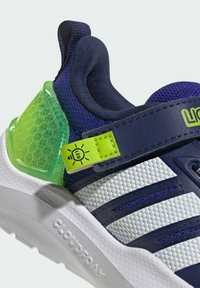Navy and white athletic shoe with a textured mesh upper, green translucent heel support, and LED accent on the strap. Rubber outsole.